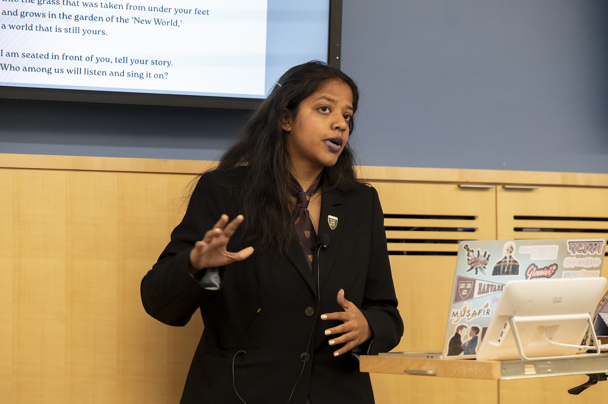 Aarya Kaushik speaks on the podium