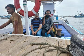 Medical workers travel by boat to an island in Pakistan