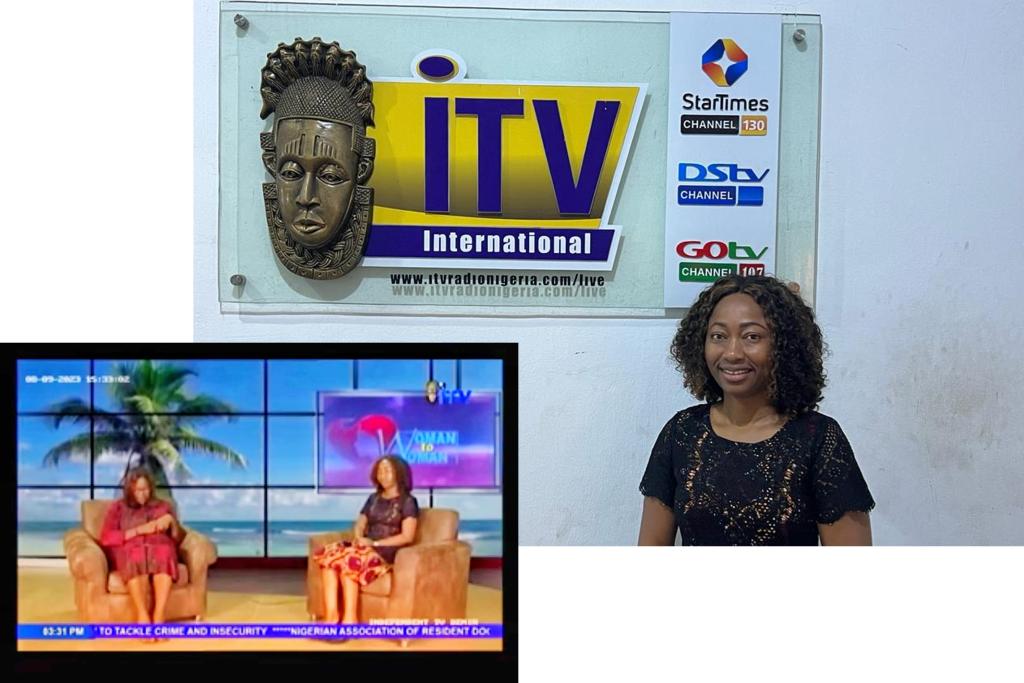 Egbe on TV talk show studio and standing in front of the studio sign