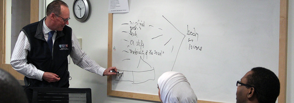 Person writing on a white board
