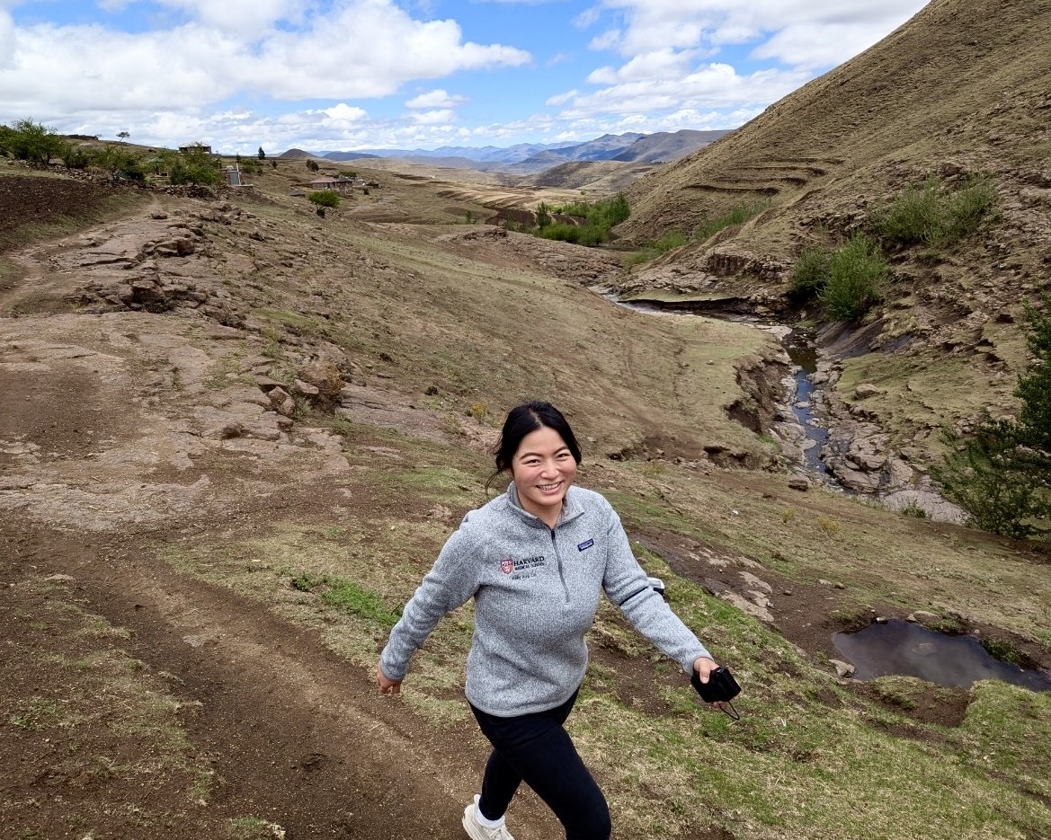 Kelly Lai hiking to a participant’s home on top of a mountain in the highlands of Lesotho.