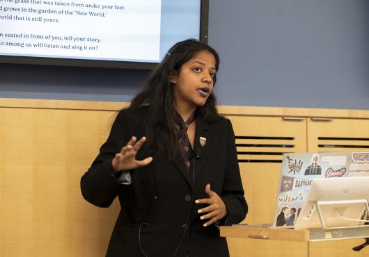 Aarya Kaushik speaks on the podium