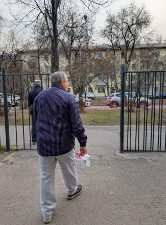 a man walking out of a metal gate