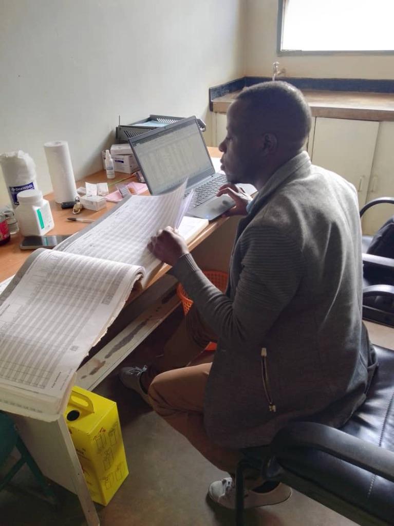 Person sitting at a desk with a book