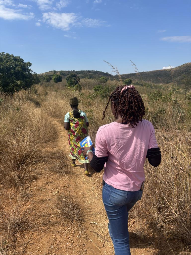 women walk on a path