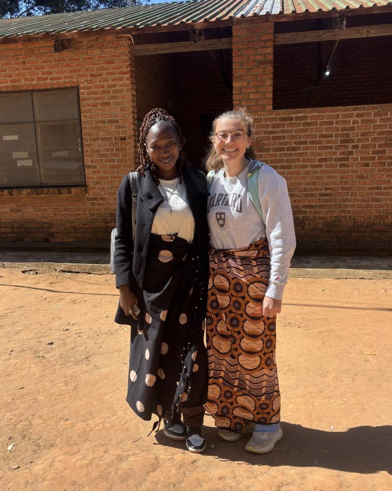 Two women in front of a building