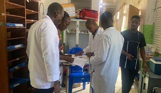 People in clinical white coats in a clinic