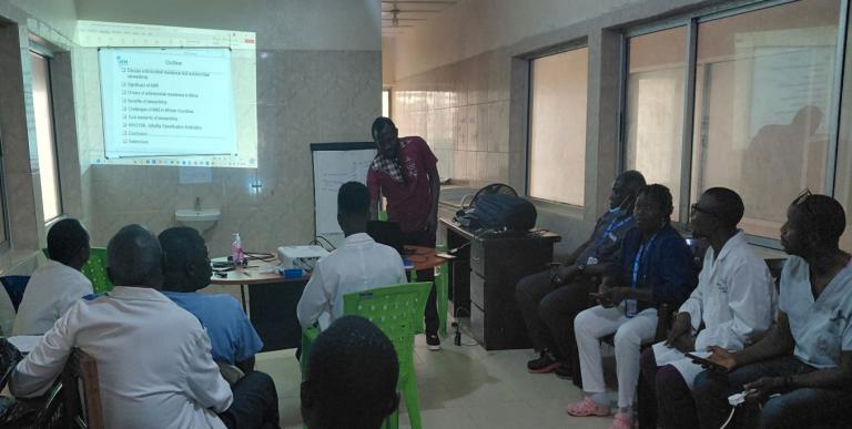 A person delivers a presentation to health care workers