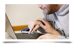 Decorative image of a person at a laptop